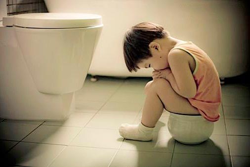 the child is sitting on the potty