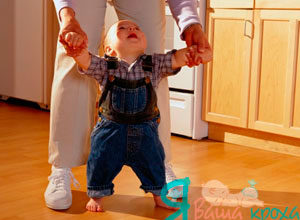 hold the baby by the hands and walk with him