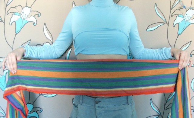 Lying on your back, put the fabric on your waist