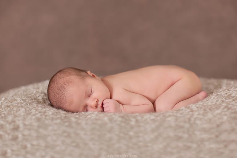 newborn sleeping on belly