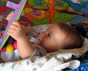 child plays with a mirror