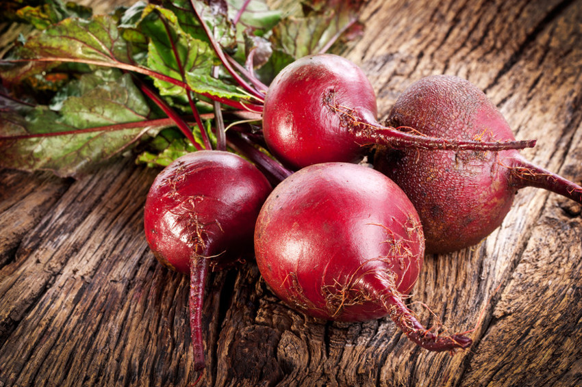 Beet roots on a old wooden table.