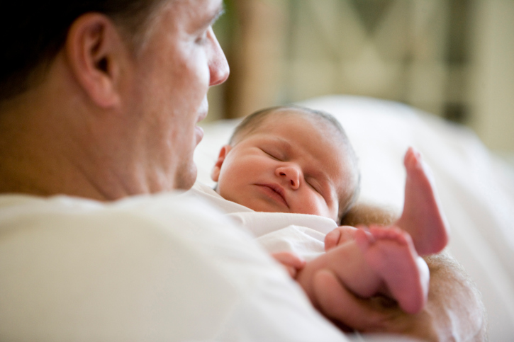 Mid adult man holding his baby