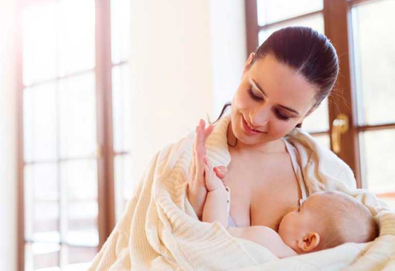 woman breastfeeding a baby