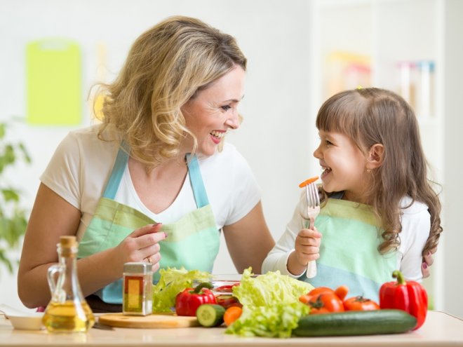 mom and child cook vegetables