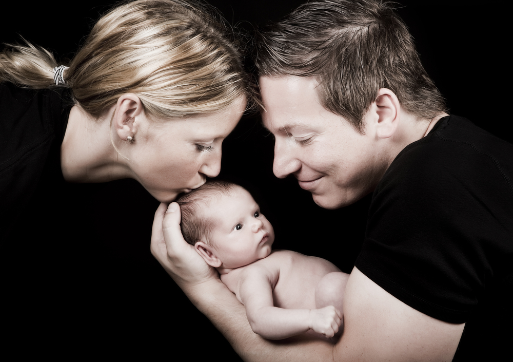 dad mom and newborn baby