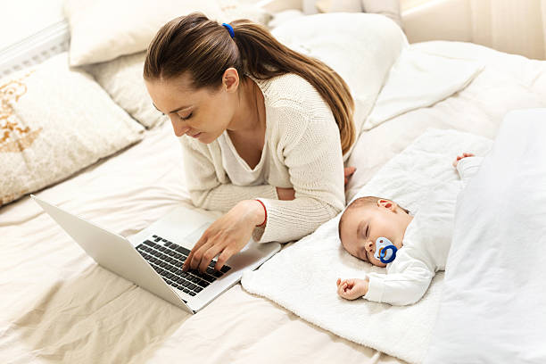 baby sleeping mom works